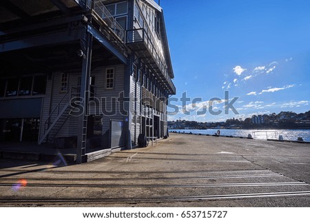 Generic cityscape with concrete floor in warehouse factory, empty ground with city in sunny day summer