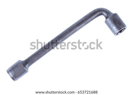 Old metal workshop wrench tool isolated on white background.