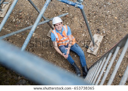 Construction Worker Suffering Injury After Accident At Work Royalty-Free Stock Photo #653738365