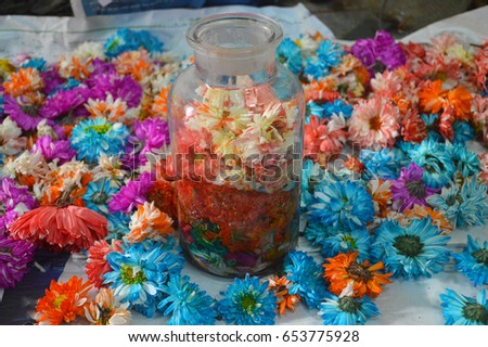 closeup flowers in glass jar on table.