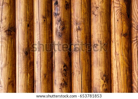 Wooden wall from logs of pine as a background texture. 