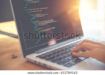 Closeup coding on screen, Woman hands coding html and programming on screen laptop, development web, developer. Royalty-Free Stock Photo #653784163