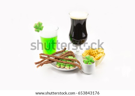 tall glass of dark beer and glass of stout bamboo green beer with tasty snacks Patrick's Day celebrations