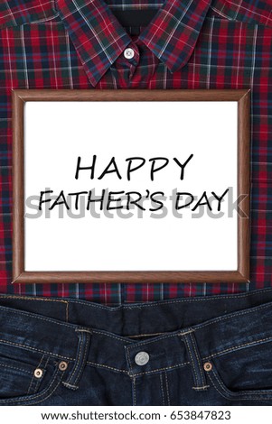 Text of happy father's day on the whiteboard with a shirt and pant for father