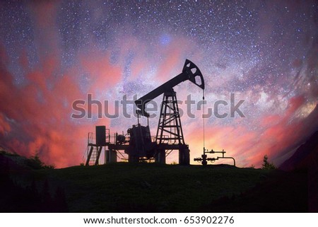 Ukraine, Carpathians night photo of the European oil rig rocking the pump on the background of the Milky Way Galaxy in the universe. Symbol of energy and ecology of planet Earth