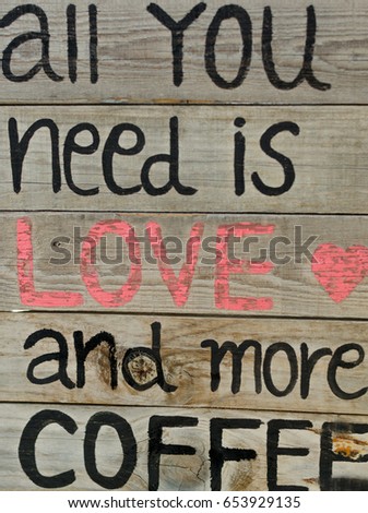 Old vintage style wood frame with quote all you need is love and more coffee for cafe decoration.
