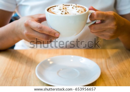 Morning coffee,hands holding cup of hot coffee latte,focus only part of the picture