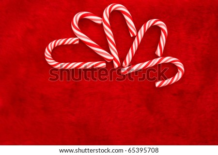 Mini candy canes on a red background, Christmas Time