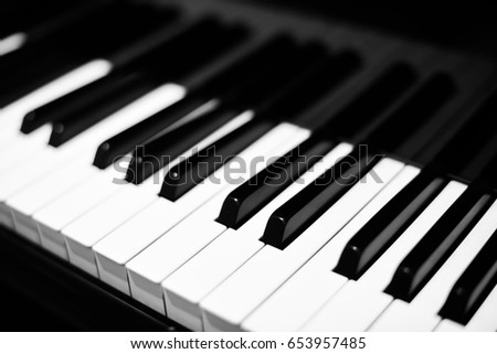 Piano keys on black piano.