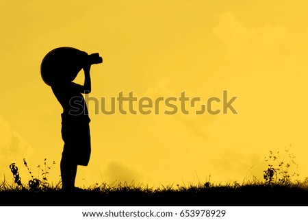 A silhouette of a little child pretend to be pirate. Kid having fun at sunset. Summer vacation and travel concept