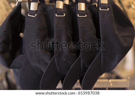 Dark Blue Baseball Hats hanging In A Row Royalty-Free Stock Photo #653987038