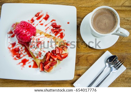 dessert ice cream strawberry crepe and hot drink in coffee shop
