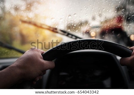Driving,bad weather conditions on the road during rain storm,selective focus and color toned.  Royalty-Free Stock Photo #654043342