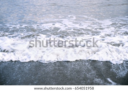 Sea, waves and foam with horizon and sky. Summer