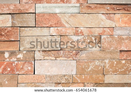 Brown or beige stone wall tiles texture.wall natural brown stone dirty,dust with pattern design or abstract 
background.