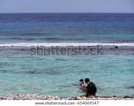 Photographer taking a picture of the beautiful turquoise sea in the Caribbeans-stock photos