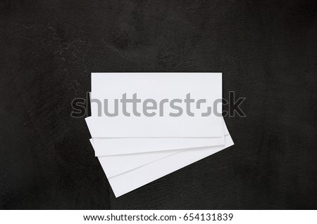 Blank business cards, envelopes, stationery on black background office desk table.