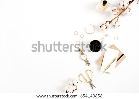 Fashion blog gold style desk with woman accessory collection: golden watches, scissors, coffee cup, notebook and cotton branch on white background. Flat lay. Top view. Royalty-Free Stock Photo #654143656
