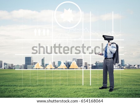 Elegant businessman outdoors with camera instead of head and media interface on screen