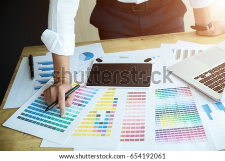 Close up hands male graphic designers,interior designer.Working on graphic tablet in modern space office.discuss data about new start up project of graphics design style and graphics design diagram