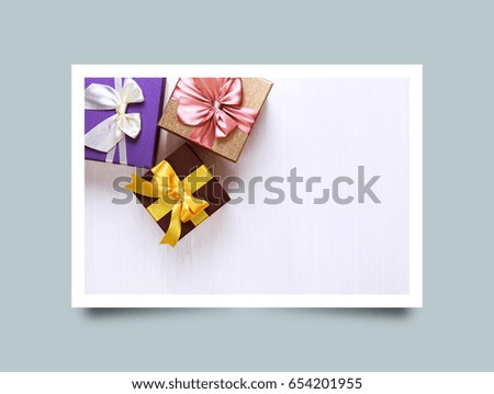 Gift boxes with bow. Colored presents wrapped with paper and ribbons. Christmas or birthday packages. Celebration design. On white table. Photo frame design with shadow.
