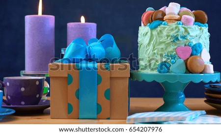 Happy Fathers Day or masculine birthday party table with showstopper cake decorated with candy, marshmallows and macarons cookies.