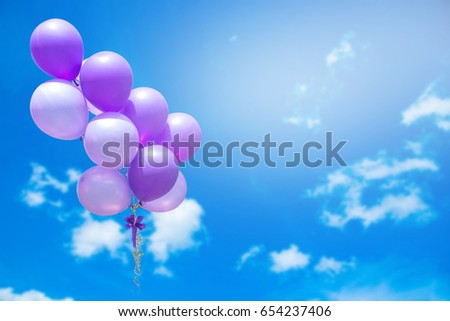 balloons against sky with clouds