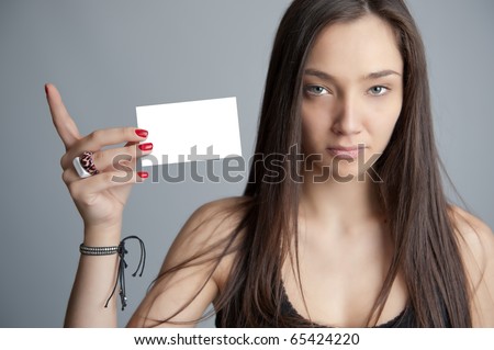 Attractive brunette holding a blank card, ideal for inserting your own message