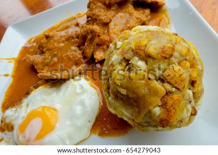 Bolon de verde with fried eggs and meat stew ecuadorian food galapagos Royalty-Free Stock Photo #654279043