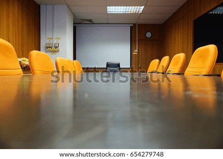 Meeting room with orange chair and LCD board. Royalty-Free Stock Photo #654279748