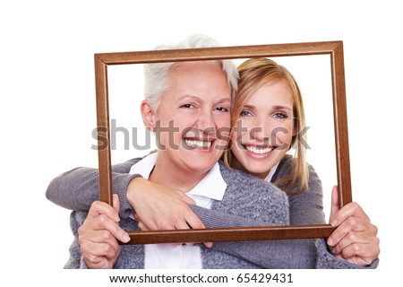 Grandmother and granddaughter looking through an empty frame