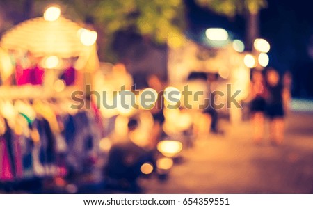 Abstract blur image of Night festival on street market for background usage. (vintage tone)
