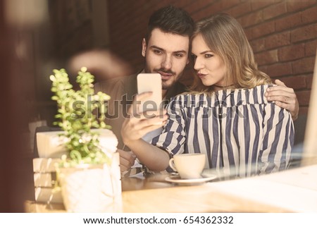 Young couple using mobile device 