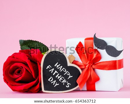 Father's day concept. Happy Father's Day message with red rose on pink background