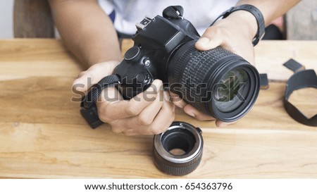 close up hand of photographer using camera