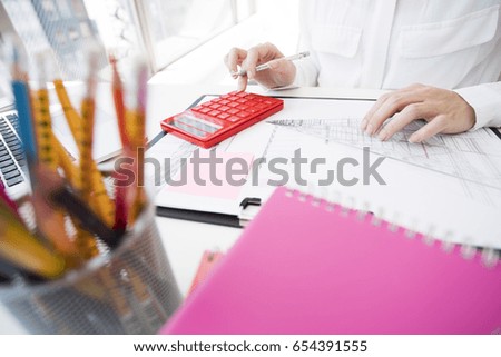 Business woman calculate with a calculator.