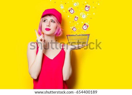 portrait of beautiful young woman with shopping bag on the wonderful yellow studio background