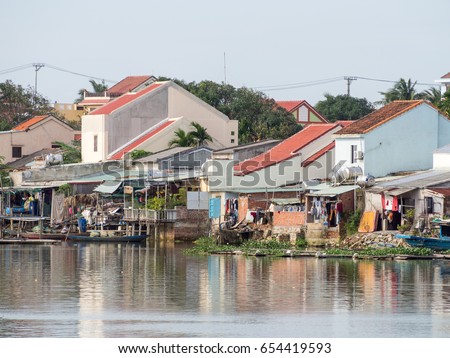 Vietnamese houses on a river, floating market and boats, traditional way of life, Hoi An town, central Vietnam