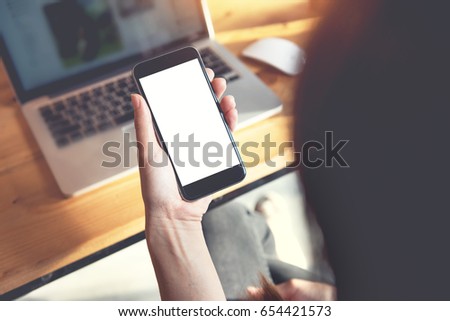 Close up of women's hands holding smart phone with blank copy space white screen for create content.