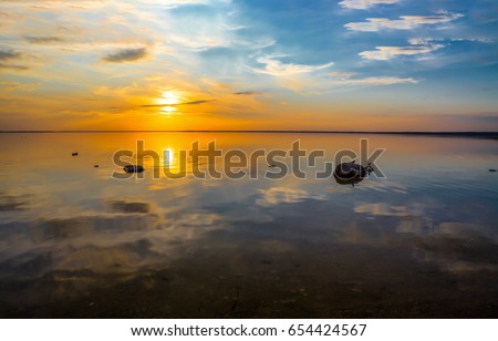 Sunset lake water view. Lake view over sunset sky Royalty-Free Stock Photo #654424567