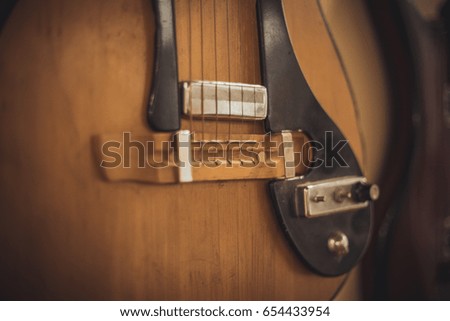 Retro bass guitar in vintage style on shelves in a musical instrument store