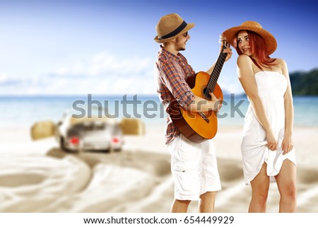 Two lovers on beach with silver car and summer time 