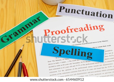 proofreading paper on table with office supplies Royalty-Free Stock Photo #654460912