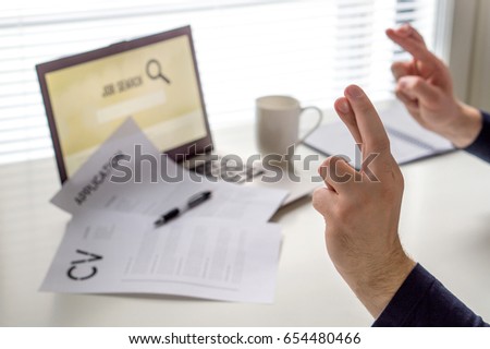 Fingers crossed to get work. Hopeful jobseeker with positive attitude. Motivated job applicant hoping to get hired after applying. Successful and happy employment. Recruitment and work hunting concept Royalty-Free Stock Photo #654480466