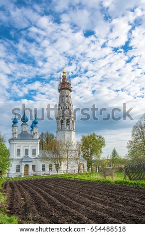 Church of the Holy Archangel Michael and the bodiless hosts in the village of Mikhailovskoye. In the foreground is a plowed field. Ivanovo oblast, Russia. 