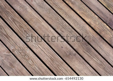 Dark brown scratched wooden cutting board. Wood background texture. Old wood plank. Bright juicy colors. Diagonal lines.
