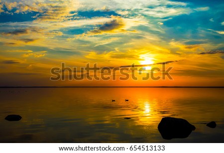 Sunset sky over lake landscape. Yellow dusk sunset sky background Royalty-Free Stock Photo #654513133