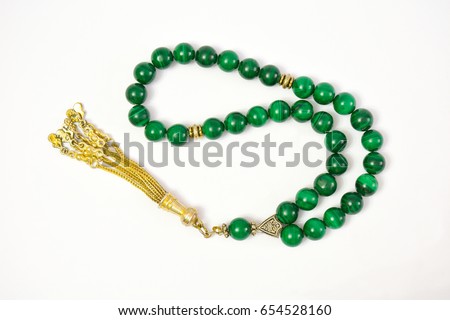 Malachite material prayer beads (rosary) on white background.  Royalty-Free Stock Photo #654528160