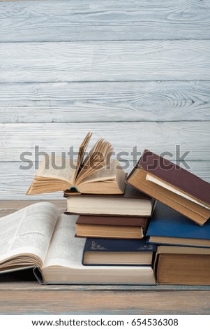 Stack of colorful books. Education background. Back to school. Book, hardback colorful books on wooden table. Education business concept. Copy space for text