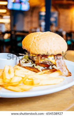 Beef and bacon hamburger with french fries - Junk and Unhealthy food style